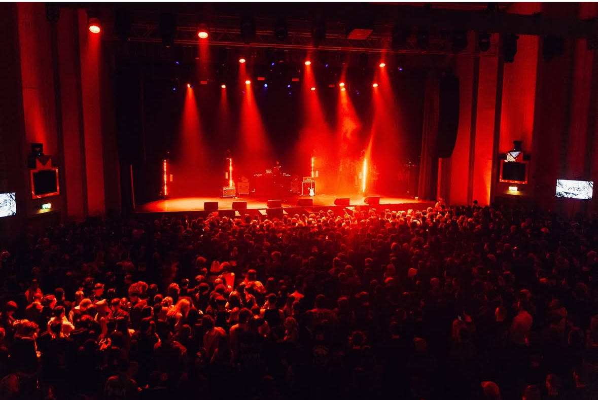 The stage and concert audience washed in red light