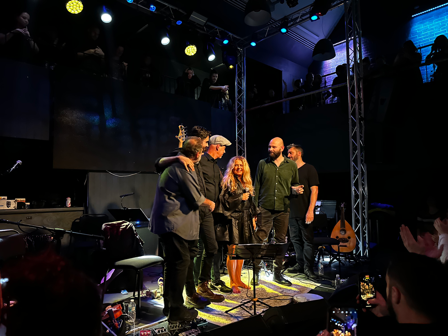 Musicians gathered at the microphones in an intimate concert venue